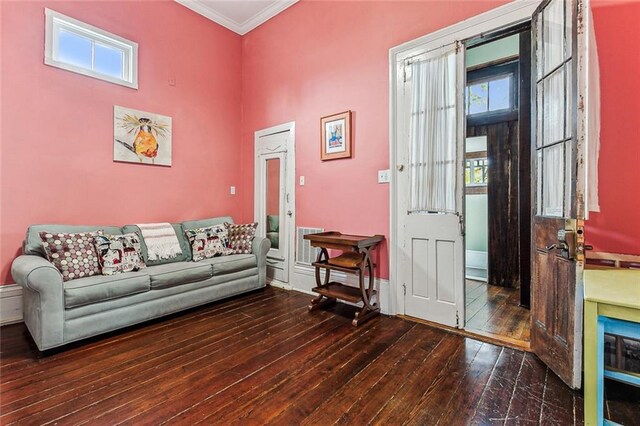 living room featuring dark hardwood / wood-style flooring and crown molding