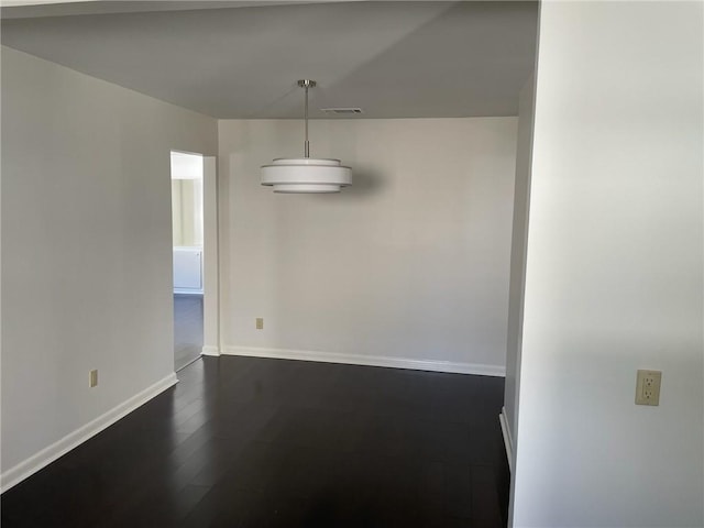 unfurnished dining area with dark wood-type flooring