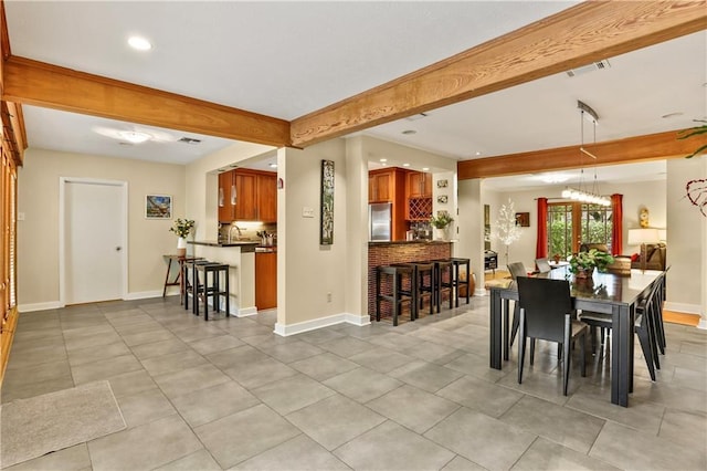 dining area featuring beam ceiling