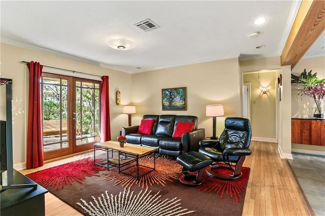 living room with french doors, ornamental molding, and hardwood / wood-style flooring