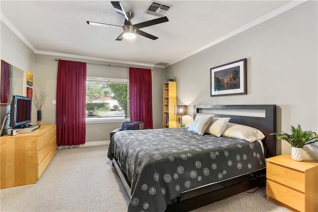 carpeted bedroom featuring ceiling fan and crown molding