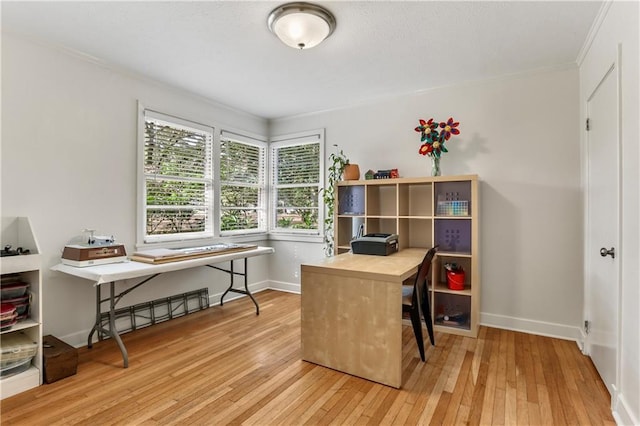 office area featuring light hardwood / wood-style floors and crown molding