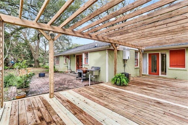 wooden deck with a patio area, water heater, and a pergola