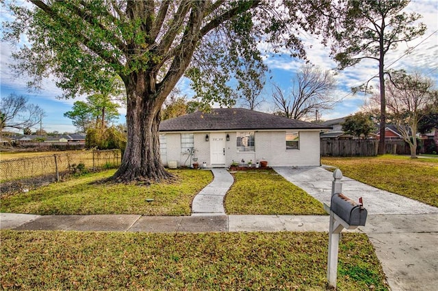 ranch-style home with a front lawn