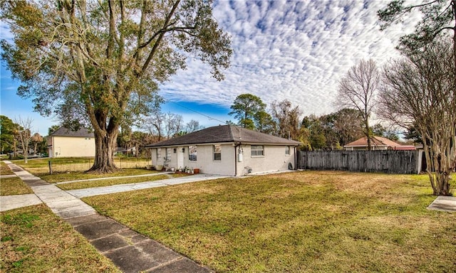 view of side of home with a yard