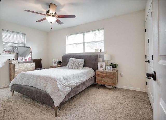 bedroom with ceiling fan and light carpet