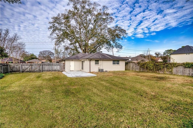 rear view of property featuring a yard and a patio