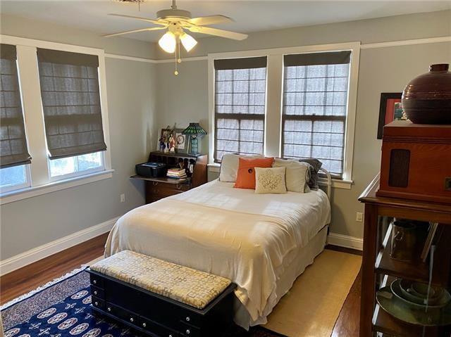 bedroom with multiple windows, dark wood-type flooring, and ceiling fan