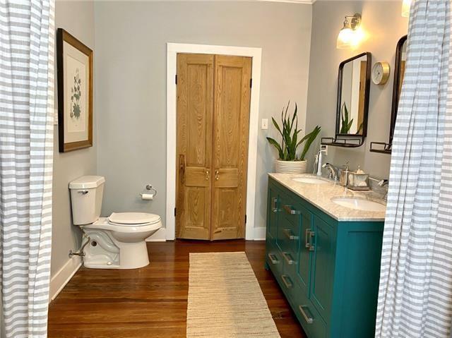 bathroom with wood-type flooring, vanity, and toilet