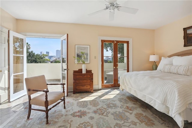 bedroom with access to exterior, french doors, and ceiling fan