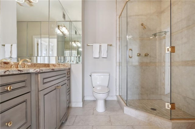 full bath with tile patterned floors, a stall shower, toilet, and vanity