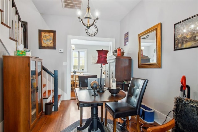 dining area featuring a chandelier and hardwood / wood-style floors