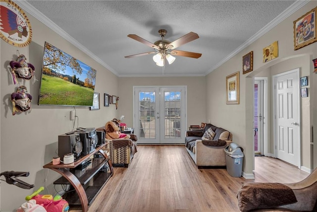 interior space featuring french doors, a textured ceiling, and ornamental molding