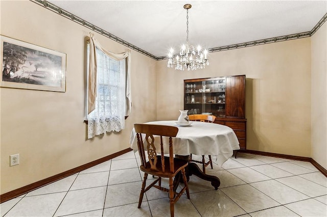 dining area with light tile patterned floors, a notable chandelier, and ornamental molding