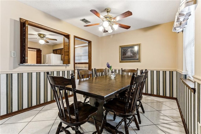 dining area with ceiling fan and light tile patterned floors