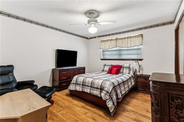 bedroom featuring a textured ceiling, ceiling fan, and light hardwood / wood-style flooring