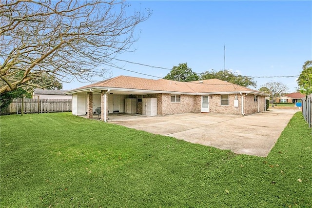 rear view of house with a patio area and a lawn