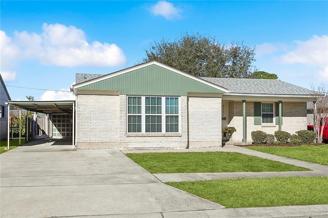 view of front of property with a carport and a front lawn