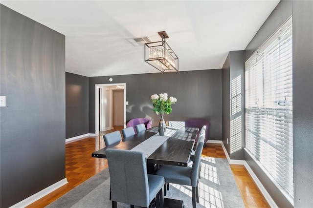 dining area featuring a notable chandelier