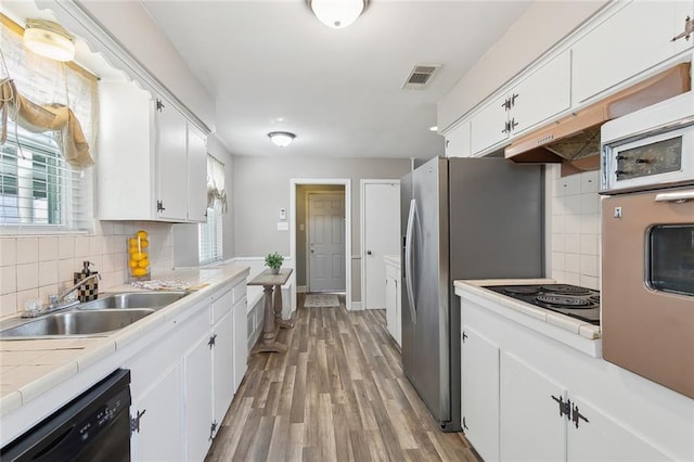 kitchen with white cabinetry, sink, tile counters, and black appliances