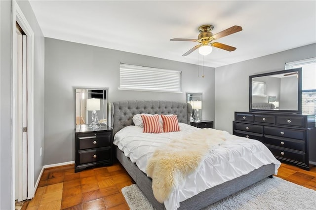 bedroom with parquet floors and ceiling fan