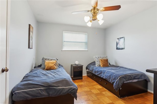 bedroom with ceiling fan and light parquet floors