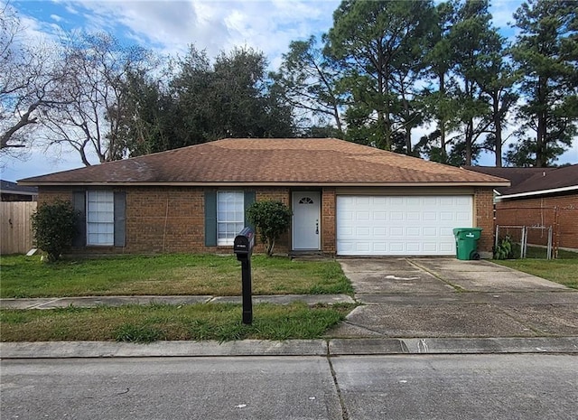 single story home featuring a garage and a front lawn