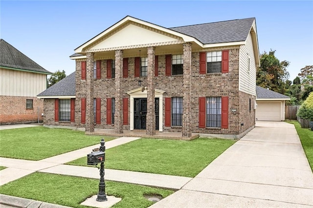 view of front of property featuring a front lawn and a garage