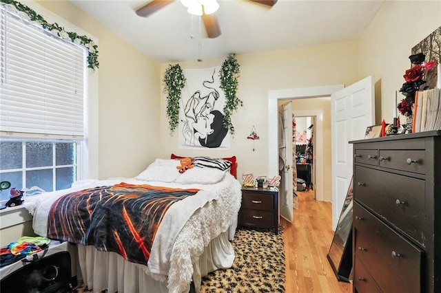 bedroom with ceiling fan and light hardwood / wood-style floors