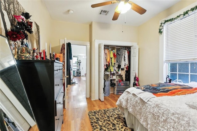 bedroom featuring ceiling fan, a closet, and light hardwood / wood-style flooring