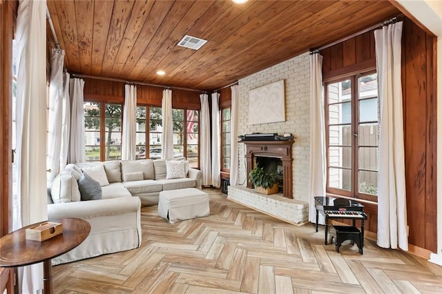 sunroom featuring wood ceiling and a healthy amount of sunlight