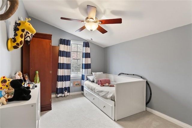 carpeted bedroom featuring ceiling fan and vaulted ceiling