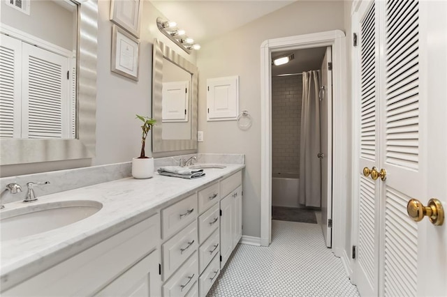 bathroom featuring vanity, vaulted ceiling, and shower / bath combo