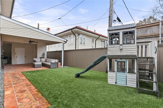 view of yard featuring a patio area, outdoor lounge area, a playground, and ceiling fan