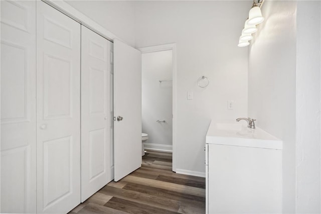 bathroom featuring hardwood / wood-style floors, toilet, and vanity