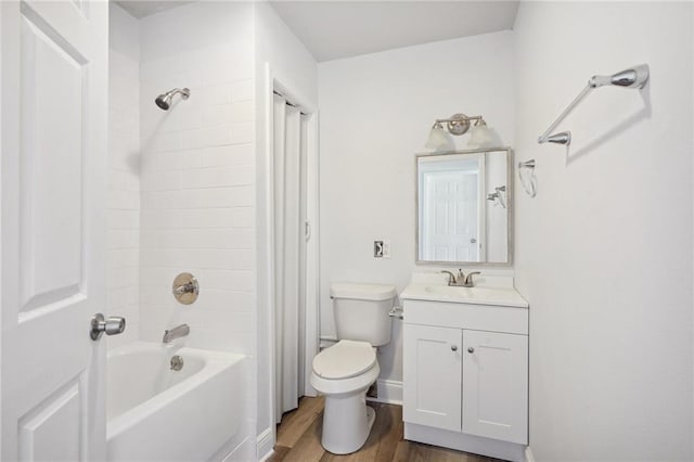 full bathroom featuring toilet,  shower combination, hardwood / wood-style flooring, and vanity