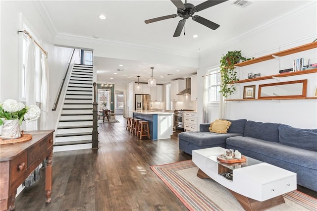 living room with ceiling fan, dark hardwood / wood-style flooring, and crown molding