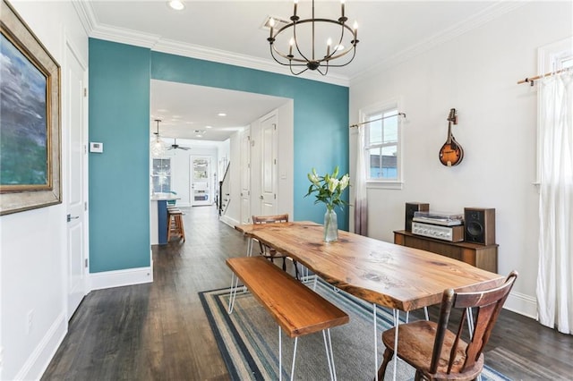 dining area featuring ornamental molding, ceiling fan with notable chandelier, and dark hardwood / wood-style floors