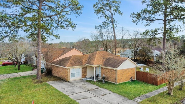 ranch-style home with a garage and a front lawn