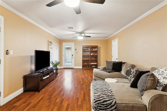 living room with dark wood-type flooring, crown molding, and ceiling fan