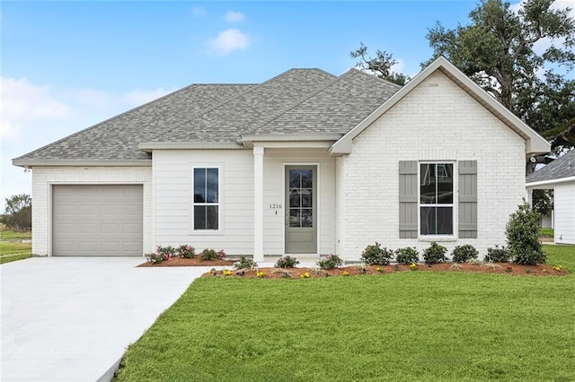 view of front of house with a garage and a front lawn