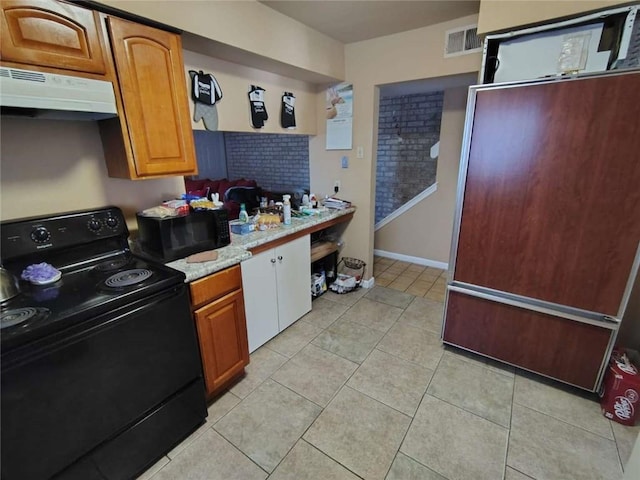 kitchen featuring light tile patterned flooring and black appliances