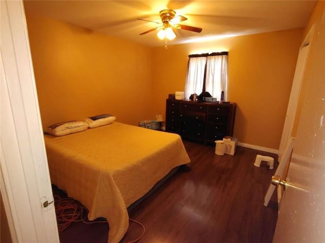 bedroom featuring ceiling fan and dark hardwood / wood-style floors