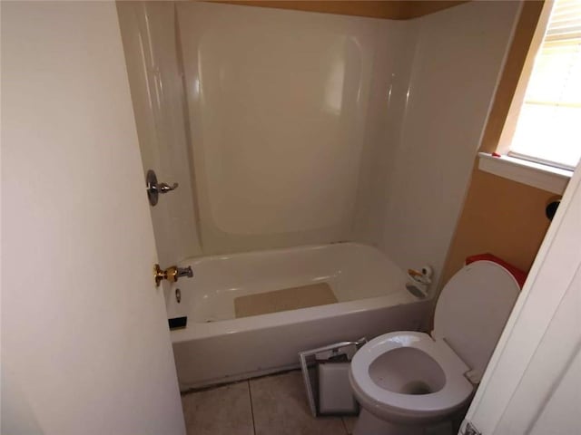 bathroom featuring toilet, shower / bath combination, and tile patterned floors