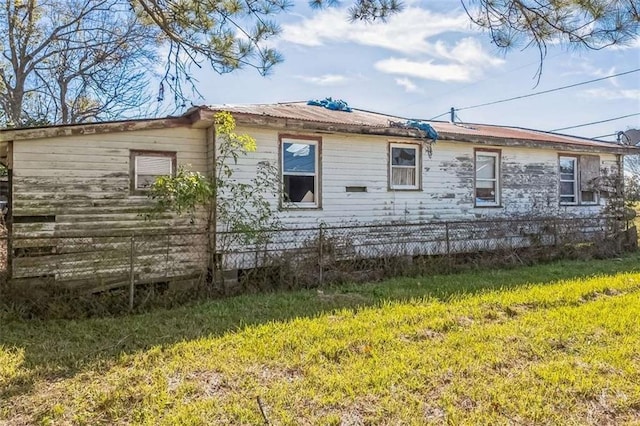 view of side of home featuring a lawn