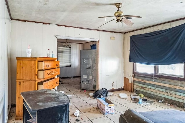 misc room featuring ceiling fan, crown molding, and wood walls