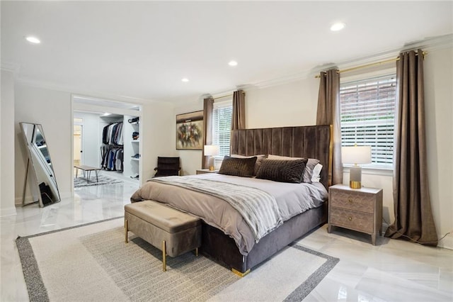 bedroom featuring a spacious closet, ornamental molding, and multiple windows