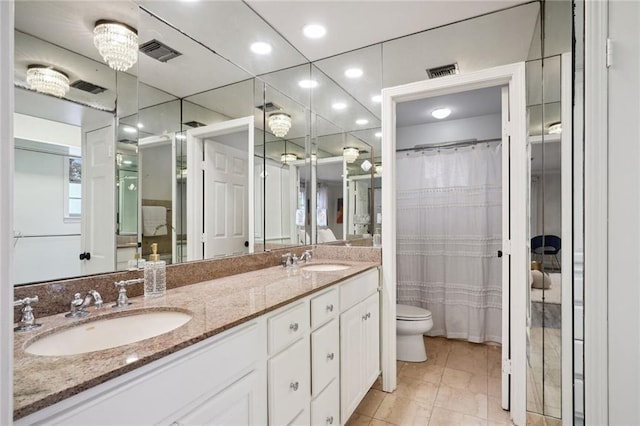 bathroom with toilet, a chandelier, walk in shower, and vanity