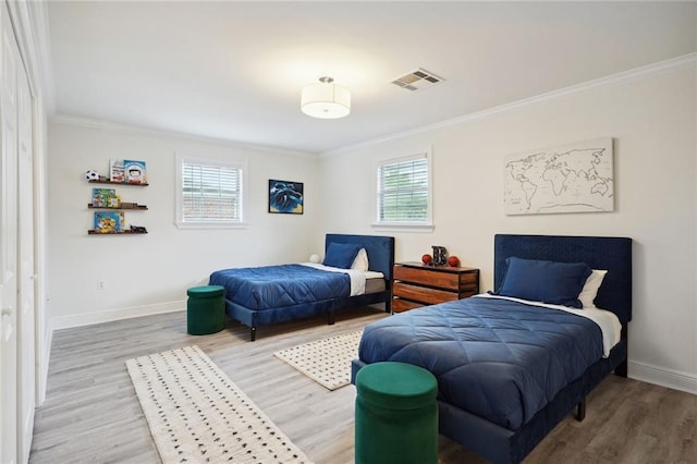 bedroom with hardwood / wood-style floors and crown molding