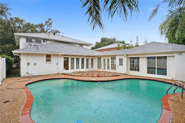 view of pool featuring french doors